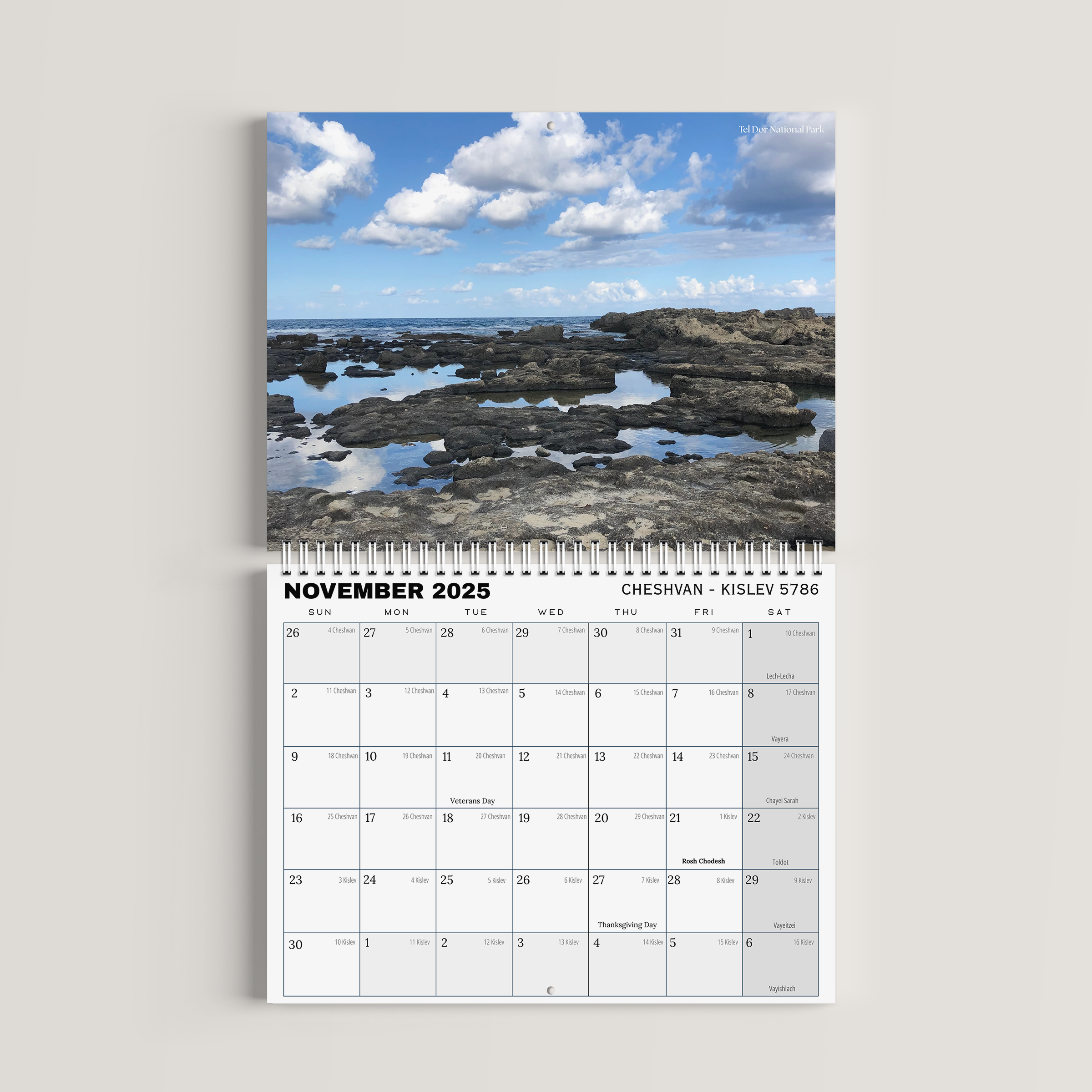 Calendar for November 2023 with a scenic view of rocks and water on a white background