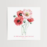 A square art print featuring a watercolor illustration of four poppies in shades of red, pink, and white with green stems, displayed on a light gray background. Below the flowers, the text reads 'Be Still And Know That I Am God' in a small red font.