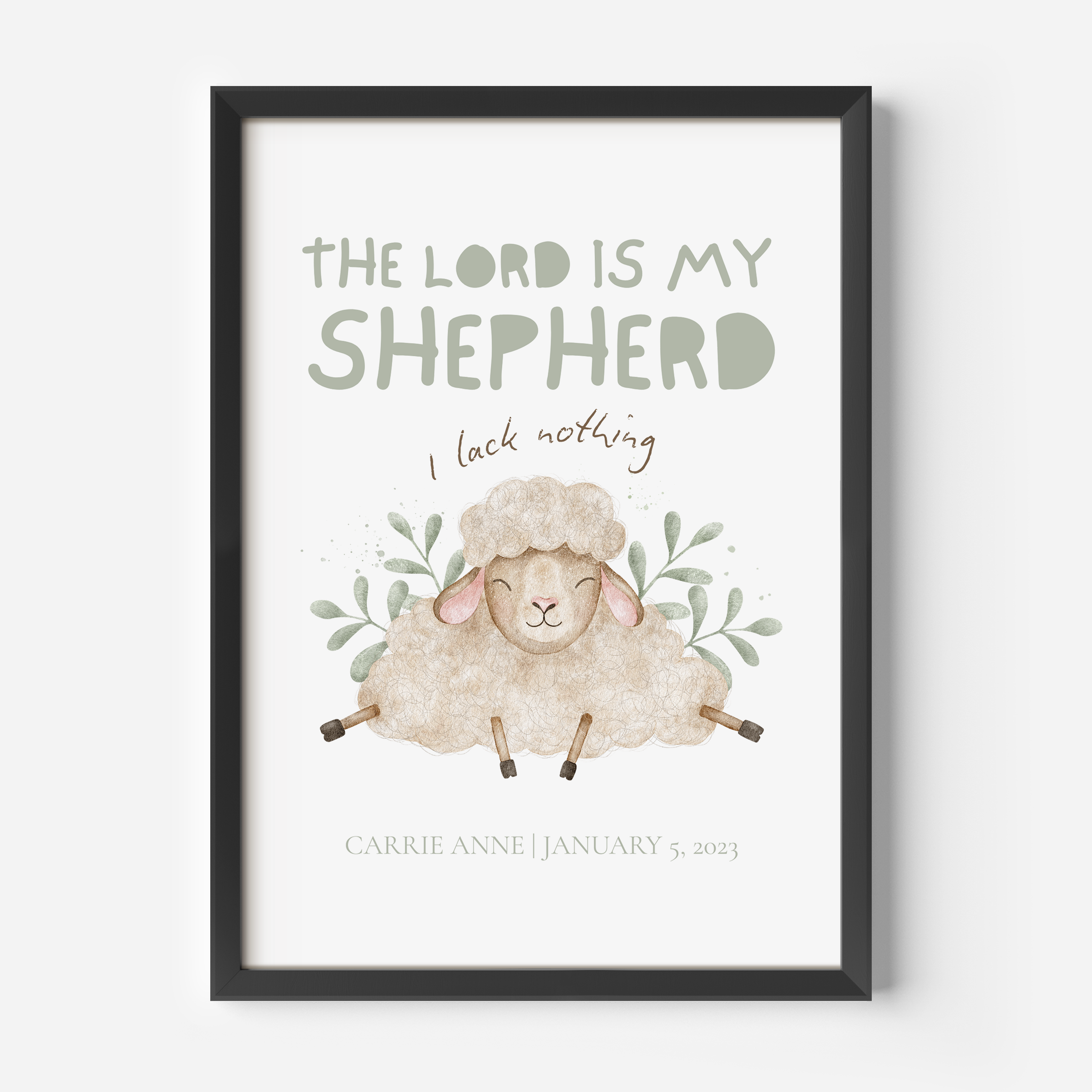 A framed personalized Christian art print featuring a watercolor illustration of a sheep with the text 'THE LORD IS MY SHEEPHERD', 'I lack nothing', and the name/date of the child